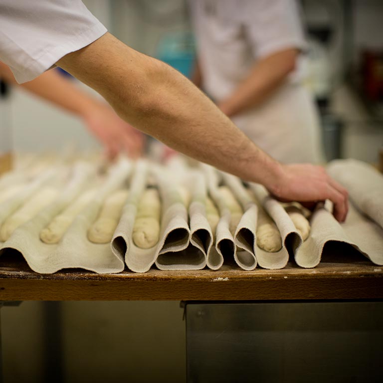 Apprenti boulanger dans le fournil de l'École des Métiers